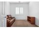 Cozy bedroom with a leather couch and built-in shelving at 9845 E Inglewood St, Mesa, AZ 85207