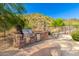 Outdoor kitchen with built-in grill and seating area at 9845 E Inglewood St, Mesa, AZ 85207