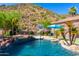 Luxury pool and spa with a putting green and outdoor kitchen at 9845 E Inglewood St, Mesa, AZ 85207