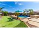 Relaxing pool area with putting green, basketball court, and mountain views at 9845 E Inglewood St, Mesa, AZ 85207