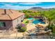Stunning backyard with a pool, spa, waterfall, putting green, and outdoor kitchen at 9845 E Inglewood St, Mesa, AZ 85207