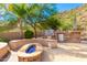 Gorgeous outdoor kitchen with built-in grill and fire pit at 9845 E Inglewood St, Mesa, AZ 85207