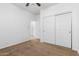 Bright bedroom with double closets and carpeted floors at 9845 E Inglewood St, Mesa, AZ 85207