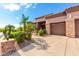 Home with a three-car garage and nicely landscaped front yard at 9845 E Inglewood St, Mesa, AZ 85207