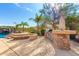 Outdoor kitchen with built-in grill and stone countertop at 9845 E Inglewood St, Mesa, AZ 85207