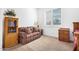 Charming bedroom with a small sofa and built-in shelving at 9845 E Inglewood St, Mesa, AZ 85207