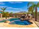 Resort-style pool with waterfall feature and mountain views at 9845 E Inglewood St, Mesa, AZ 85207