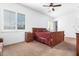Well-lit bedroom with a ceiling fan and double doors at 9845 E Inglewood St, Mesa, AZ 85207