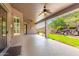 Spacious covered patio with ceiling fans, offering views of the backyard at 9845 E Inglewood St, Mesa, AZ 85207