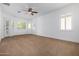 Spacious bedroom with neutral carpeting, ceiling fan and French doors at 9845 E Inglewood St, Mesa, AZ 85207
