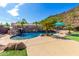 Inviting pool and spa surrounded by lush landscaping and a waterfall feature at 9845 E Inglewood St, Mesa, AZ 85207
