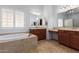 Bathroom boasts double vanity and a large soaking tub at 9845 E Inglewood St, Mesa, AZ 85207