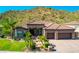Single-story home with a three-car garage and mountain views at 9845 E Inglewood St, Mesa, AZ 85207