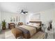 Main bedroom with a large bed, brown accents, and wood-look floors at 9614 E Bud Ct, Sun Lakes, AZ 85248