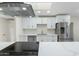 Modern kitchen with white shaker cabinets, quartz countertops, and stainless steel appliances at 9614 E Bud Ct, Sun Lakes, AZ 85248