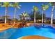 Luxury pool and spa with waterfall and palm trees at 19301 N Ponderosa Ct, Surprise, AZ 85387