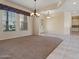 Well-lit dining room featuring tiled floors and a chandelier at 19301 N Ponderosa Ct, Surprise, AZ 85387