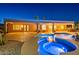 Luxury pool and spa with a serene nighttime ambiance at 19301 N Ponderosa Ct, Surprise, AZ 85387