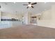 Spacious living area with carpeting and views into the kitchen at 19301 N Ponderosa Ct, Surprise, AZ 85387