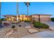 Exterior view of a single-story house with a landscaped front yard and palm trees at 19301 N Ponderosa Ct, Surprise, AZ 85387