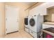 Laundry room with washer, dryer, and extra storage space at 15226 S 18Th Dr, Phoenix, AZ 85045