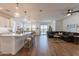 Open concept kitchen with white cabinets, large island, and stainless steel appliances at 379 E Las Puertas Ln, Queen Creek, AZ 85140