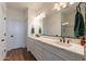 Double vanity bathroom with white cabinets and quartz countertops at 379 E Las Puertas Ln, Queen Creek, AZ 85140