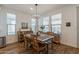 Bright dining room with hardwood floors and a rustic wooden dining table at 379 E Las Puertas Ln, Queen Creek, AZ 85140