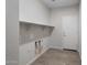 Laundry room with built-in shelving and a door at 1473 W Saddle Run, Apache Junction, AZ 85120