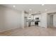 Bright kitchen with white cabinets, stainless steel appliances, and wood-look floors at 1521 W Saddle Run, Apache Junction, AZ 85120