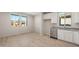 Modern kitchen featuring white cabinets, stainless steel appliances, and wood-look flooring at 1521 W Saddle Run, Apache Junction, AZ 85120