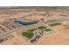 Aerial view of Blossom Rock community, showing homes, parks, and a lake at 1449 W Saddle Run, Apache Junction, AZ 85120