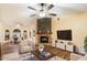 Living room with fireplace, hardwood floors, and built-in entertainment center at 17302 E Oro Grande Dr, Fountain Hills, AZ 85268