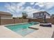 Stunning pool with a waterfall feature and lounge chairs at 20165 W Hadley St, Buckeye, AZ 85326