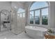 Relaxing bathroom with a large soaking tub and window views at 12222 N 74Th St, Scottsdale, AZ 85260