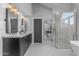Modern bathroom with double sinks and a herringbone tile floor at 12222 N 74Th St, Scottsdale, AZ 85260