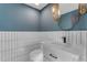 Chic powder room with a modern vanity and blue and white tile at 12222 N 74Th St, Scottsdale, AZ 85260