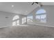 Spacious bonus room with vaulted ceiling, large windows, and carpet flooring at 12222 N 74Th St, Scottsdale, AZ 85260