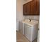 Laundry room with washer, dryer, and upper cabinets at 25241 W Wayland Dr, Buckeye, AZ 85326