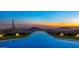 Infinity pool and mountain view at sunset at 42515 N 102Nd St, Scottsdale, AZ 85262