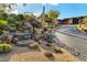 Landscaped front yard with a long paved driveway leading to a modern home at 42515 N 102Nd St, Scottsdale, AZ 85262