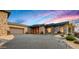 Stunning contemporary home exterior with stone and wood accents at 42515 N 102Nd St, Scottsdale, AZ 85262