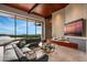 Modern living room with a large sectional sofa and a linear fireplace at 42515 N 102Nd St, Scottsdale, AZ 85262