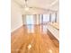 Hardwood floors and sliding doors to backyard shown in this open living area at 1639 E Redfield Rd, Gilbert, AZ 85234