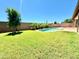Landscaped backyard oasis featuring a sparkling pool at 1639 E Redfield Rd, Gilbert, AZ 85234