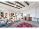 Relaxing living room with exposed wooden beams, comfortable seating, and large windows at 50381 W Century Rd, Maricopa, AZ 85139