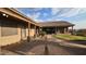 Landscaped backyard with covered patio and walkway at 376 N Iron Horse Dr, Coolidge, AZ 85128