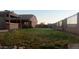 Spacious backyard with grassy lawn, covered patio, and a large fence at 376 N Iron Horse Dr, Coolidge, AZ 85128