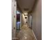 Long hallway with tile floors and access to laundry and bedrooms at 376 N Iron Horse Dr, Coolidge, AZ 85128