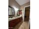 Double vanity bathroom with granite countertops and tiled floors at 376 N Iron Horse Dr, Coolidge, AZ 85128